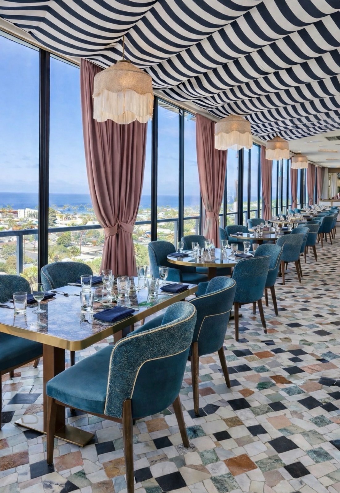 The Aries dining room with striped ceiling, blush drapery and Pacific Ocean views